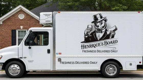 White truck with Henrique's Board logo parked in front of a house